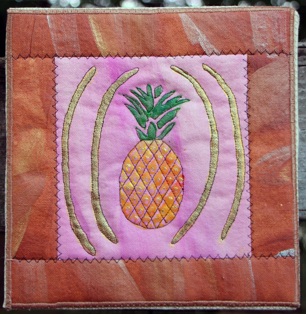 Pineapple  with gold accents on pink with tan accented border