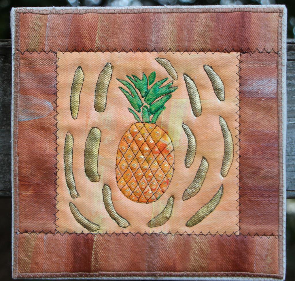 Pineapple  with gold accents on pink with tan accented border